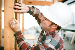 Wooden Door Frame Measured By A Workmen