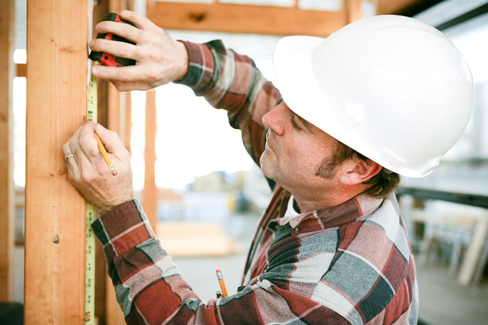 Carpenter measuring a frame