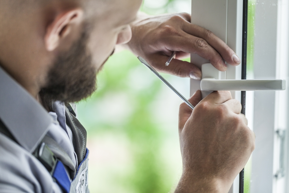 Man installing lock on a door